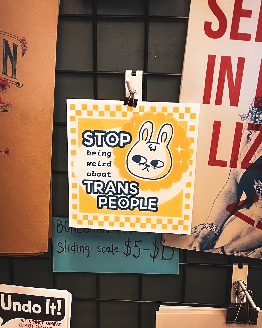 a print by mothfruit on bsky at boneshaker books that says stop being weird about trans people