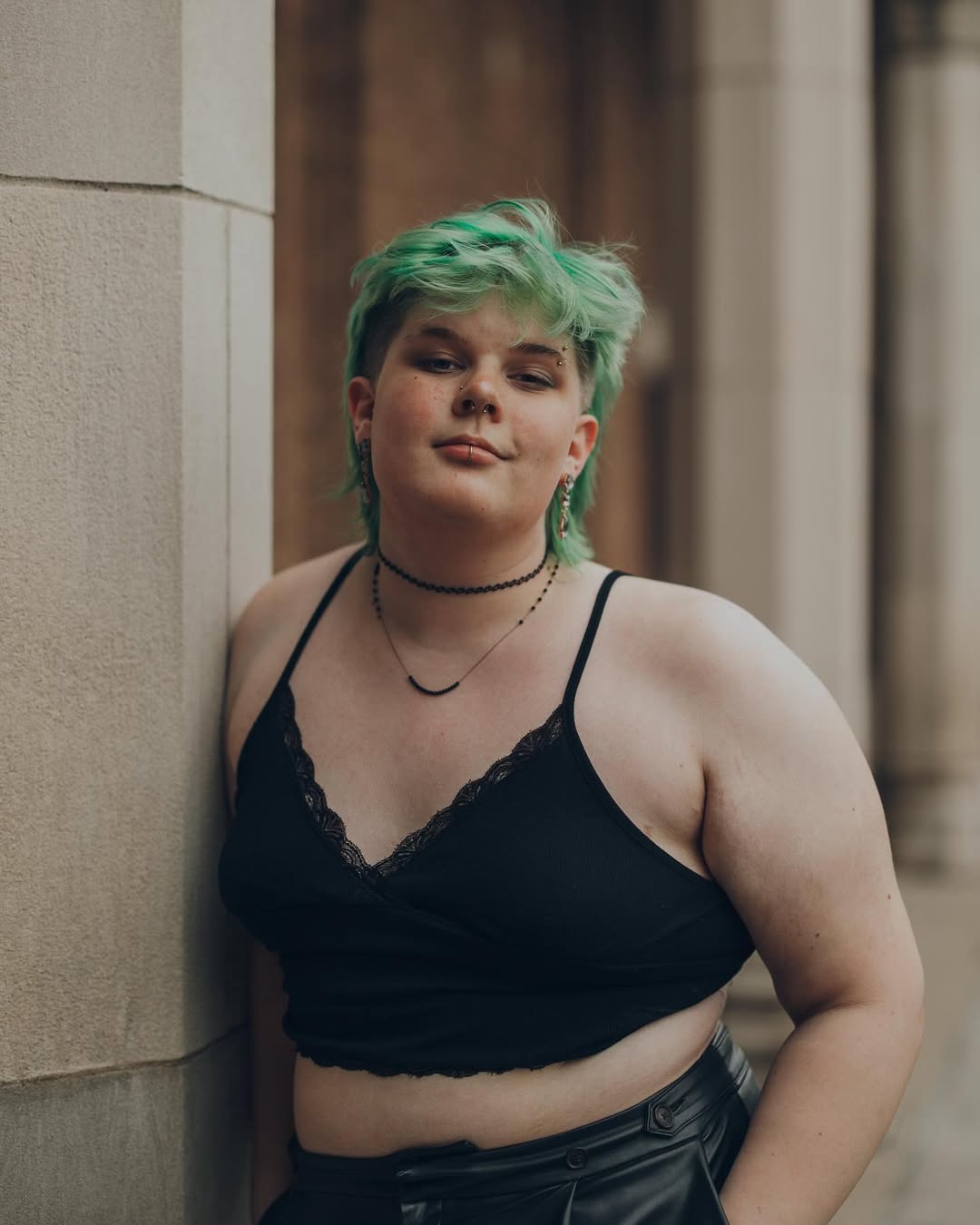 photo of amara standing against same pillar