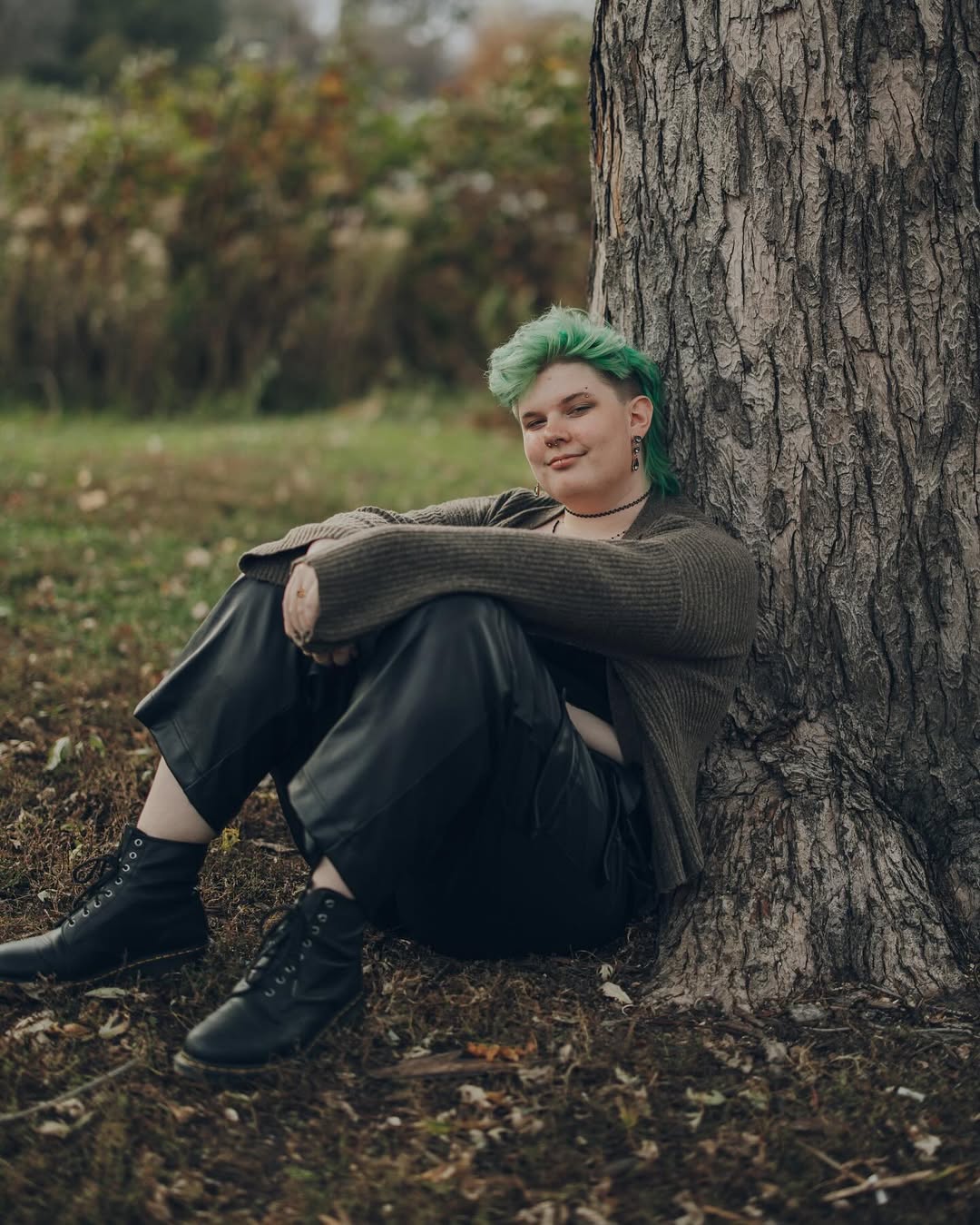 photo of amara with the cardigan sitting against a tree