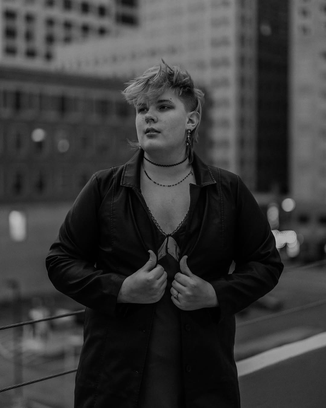 b/w photo of amara with hands on leather trenchcoat