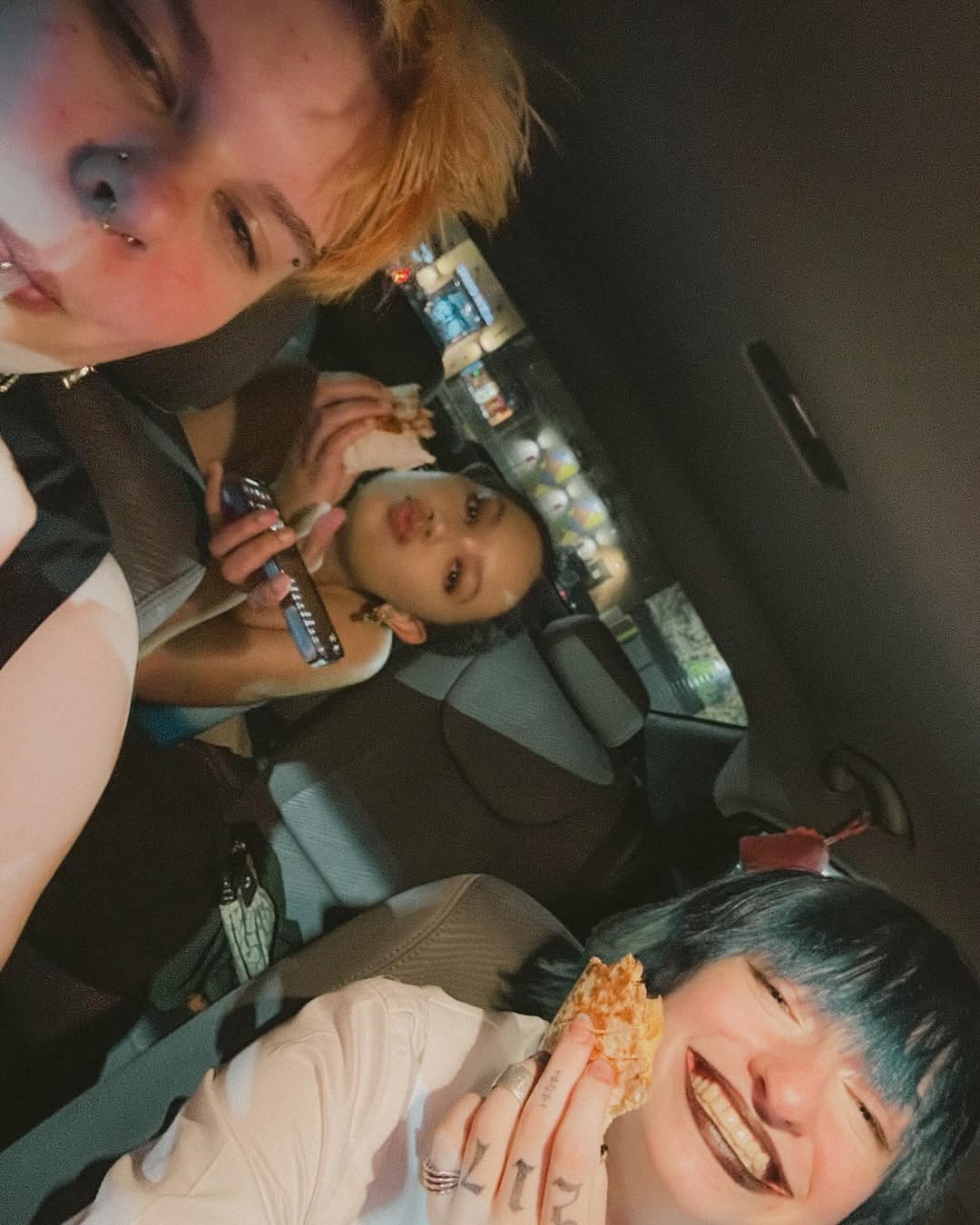 photo of amara, cal, and ella sitting in the car eating food