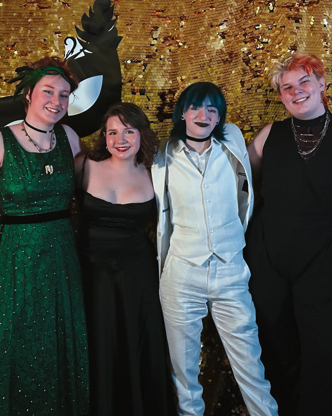 photo of amara, cal, vivian, and abby in front of the gala backdrop