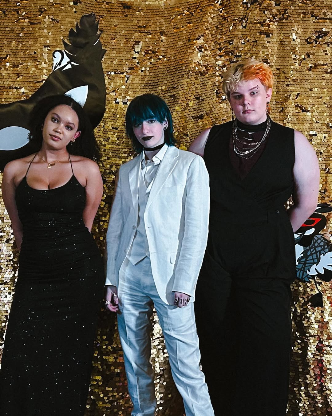 photo of amara, cal, and ella in front of the gala backdrop