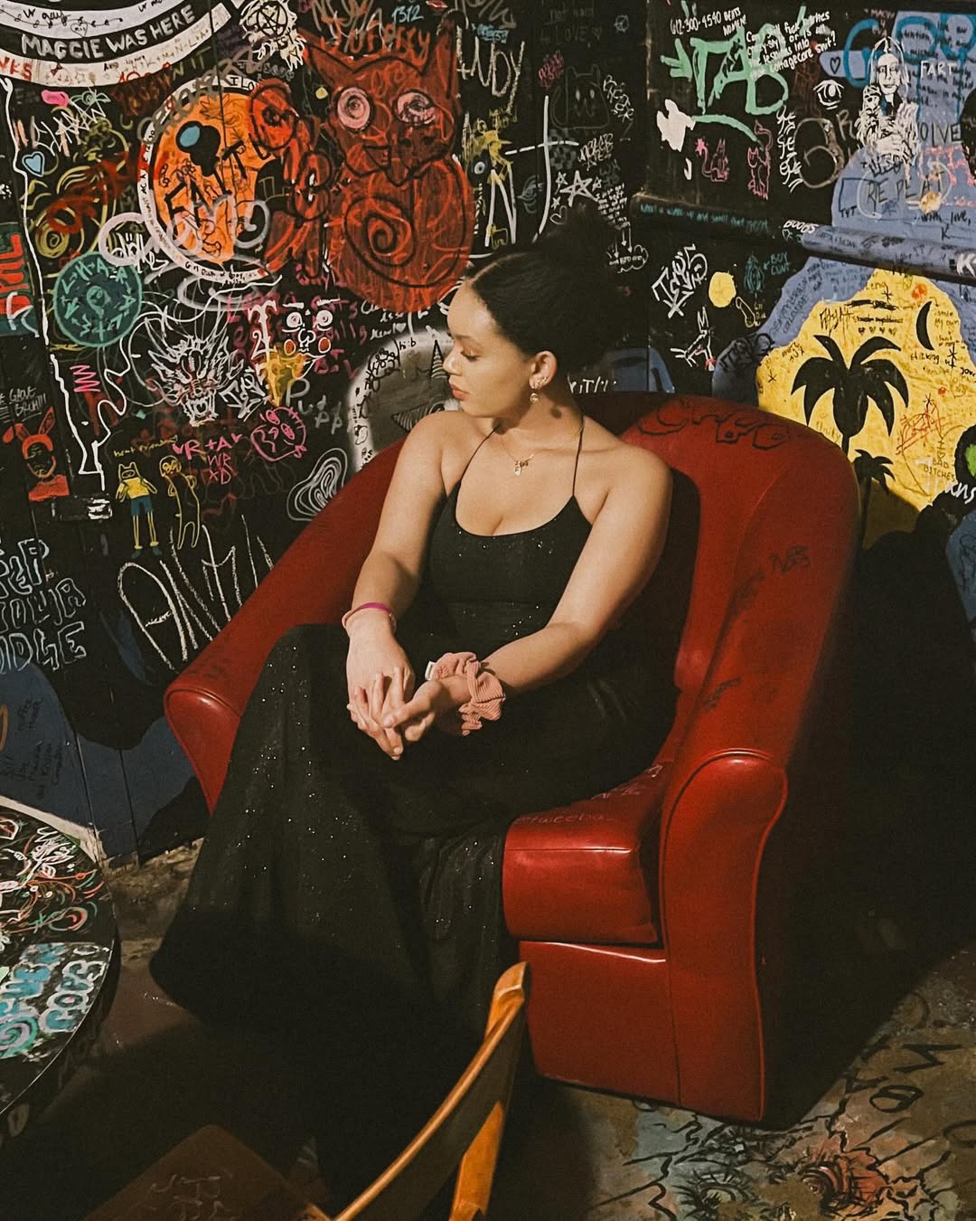 photo of ella sitting in a red chair